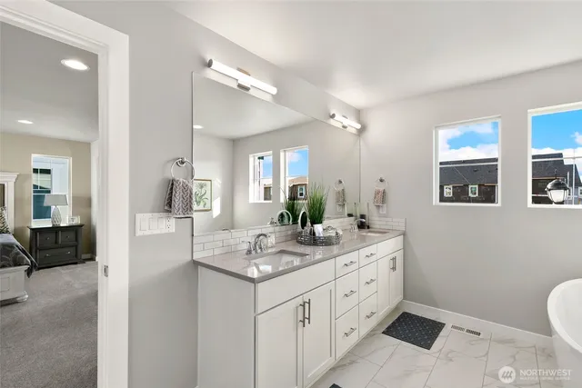 a spacious bathroom with a granite countertop sink mirror and toilet