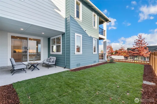 a view of a patio with table and chairs potted plants and a large tree