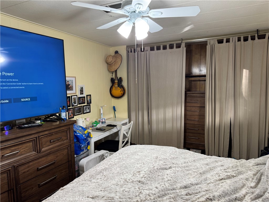 929 East Foothill Boulevard, Unit 91 Upland, CA 91786 - Photo 15 of 32 a bedroom with a bed and a chandelier