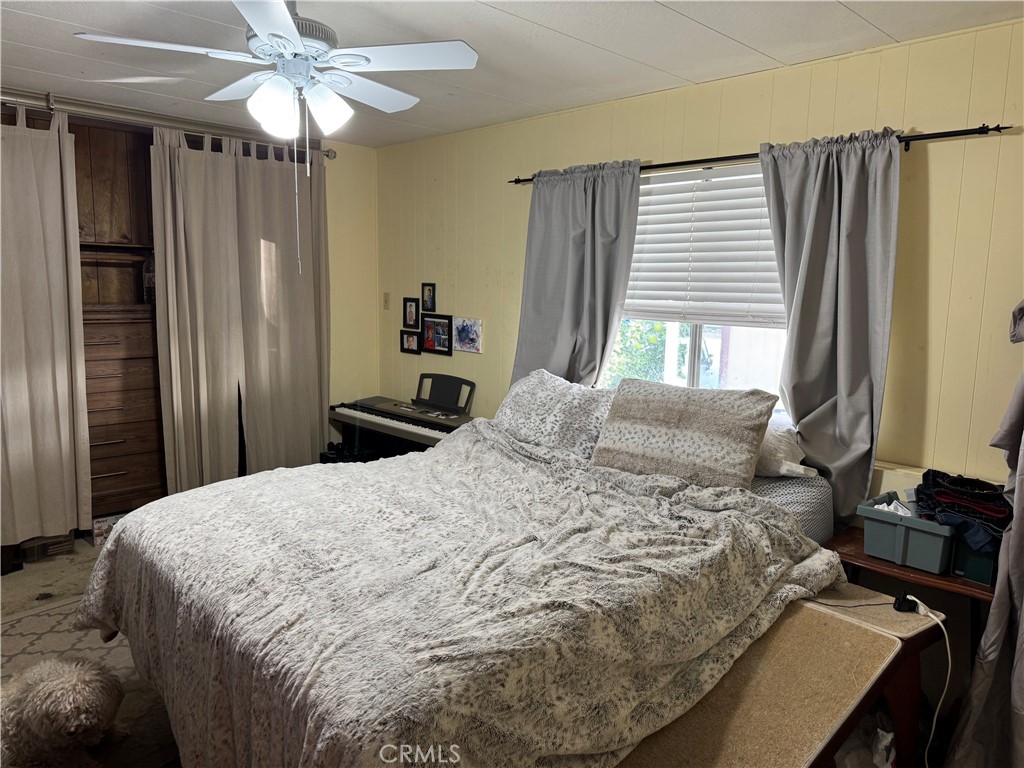 929 East Foothill Boulevard, Unit 91 Upland, CA 91786 - Photo 19 of 32 a bedroom with a bed and a chandelier