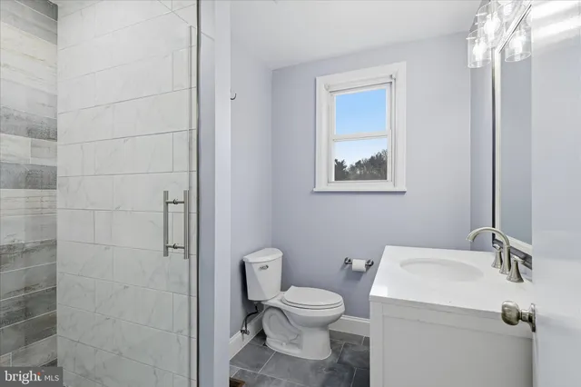 a bathroom with a toilet sink and shower