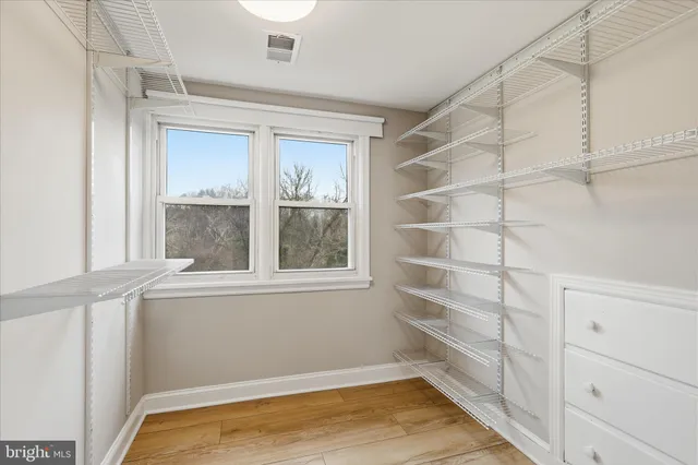 a view of a room with rack on the wall and a window