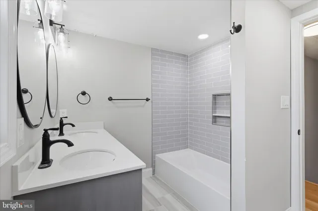 a bathroom with a sink a mirror and a bathtub