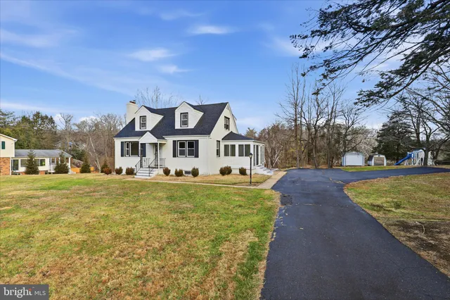 a front view of a house with a yard and fountain