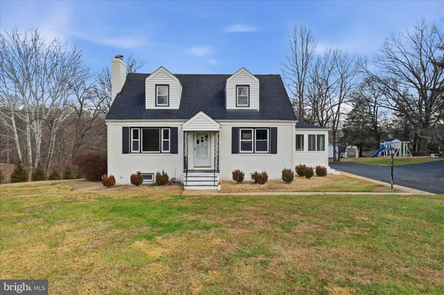 a view of a house with a yard and sitting area