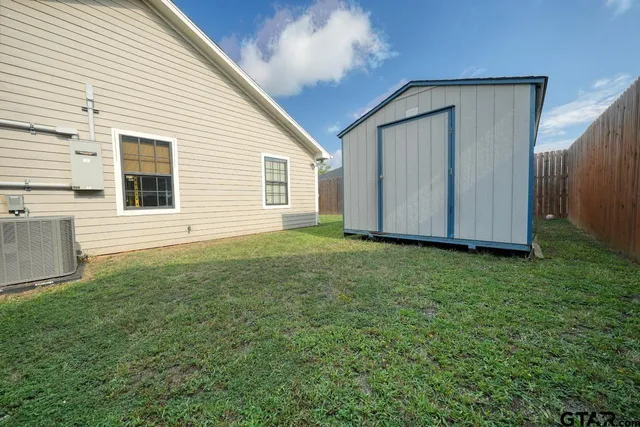 a view of house with backyard