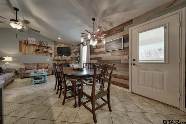 a view of a dining room with furniture and chandelier