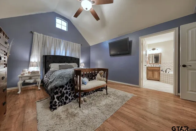 a bedroom with a bed and flat screen tv