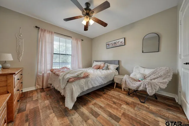 a spacious bedroom with a bed and a chandelier