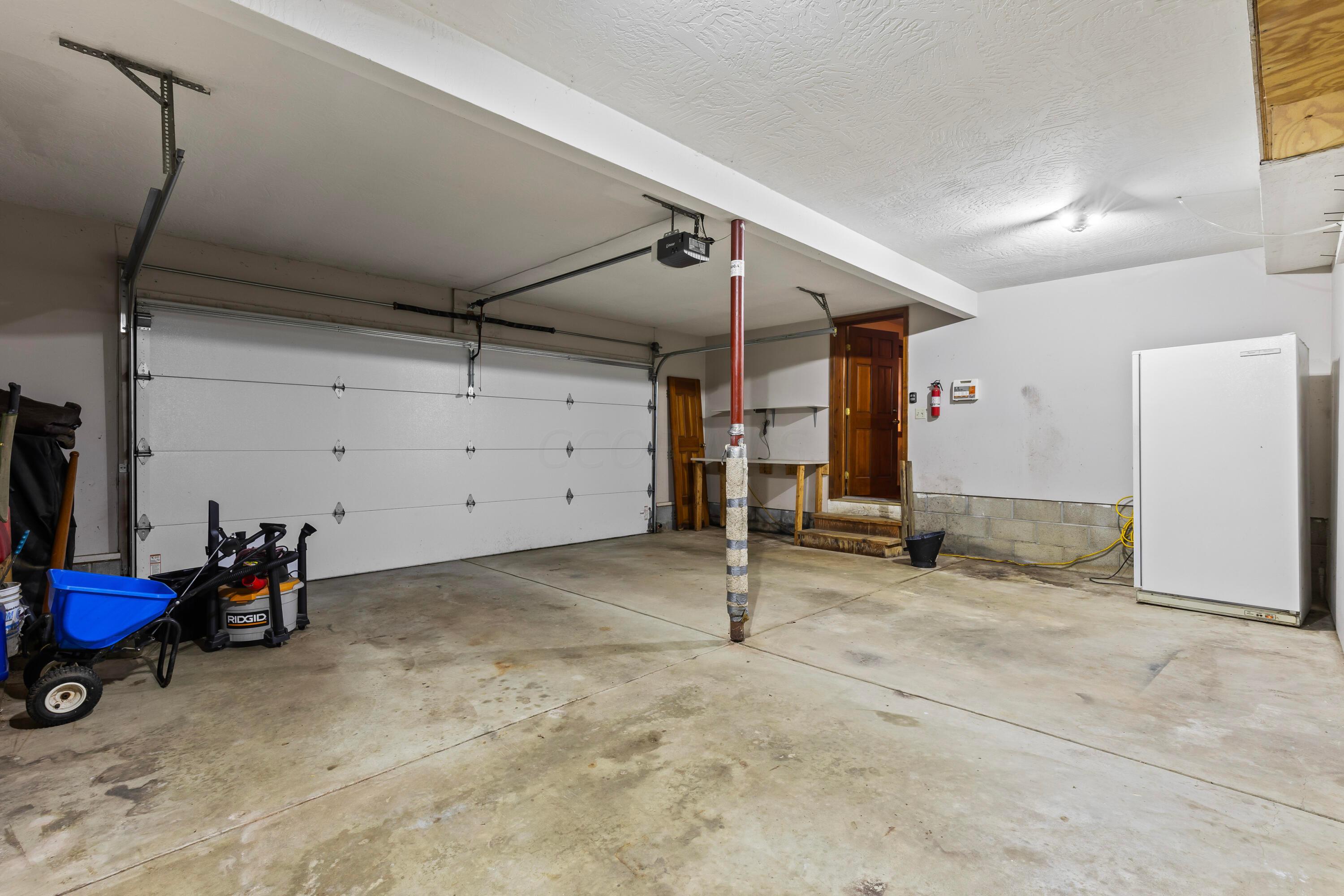6940 Graham Road Mount Vernon, OH 43050 - Photo 32 of 70 • 2+ car attached
• Finished walls & ceiling
• Linear® electric door opener
• Rear service door
• Wall shelves