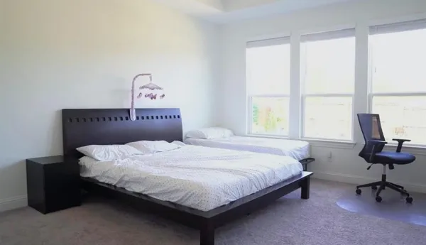 a bedroom with a bed and a window