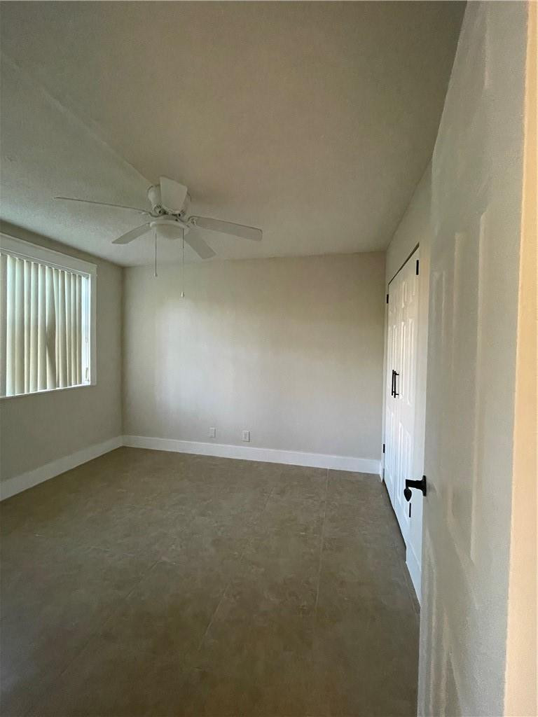 8801 Wiles Road, Unit 108 Coral Springs, FL 33067 - Photo 15 of 22 an empty room with windows and closet