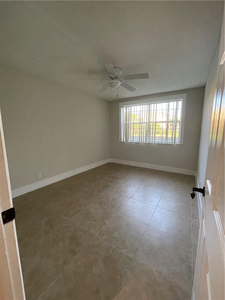 8801 Wiles Road, Unit 108 Coral Springs, FL 33067 - Photo 16 of 22 an empty room with windows