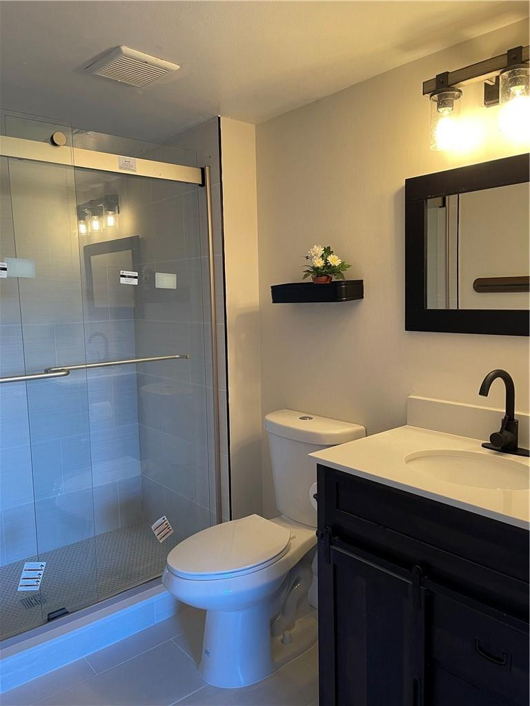 8801 Wiles Road, Unit 108 Coral Springs, FL 33067 - Photo 19 of 22 a bathroom with a sink a toilet and shower