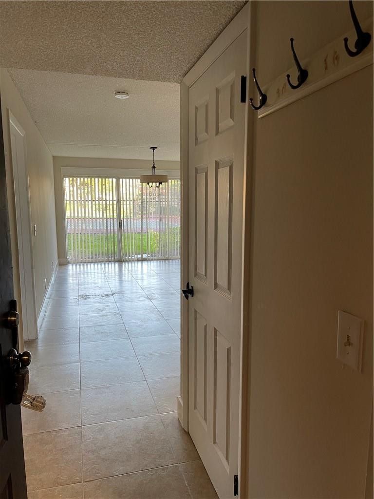 8801 Wiles Road, Unit 108 Coral Springs, FL 33067 - Photo 20 of 22 a view of a hallway with a porch