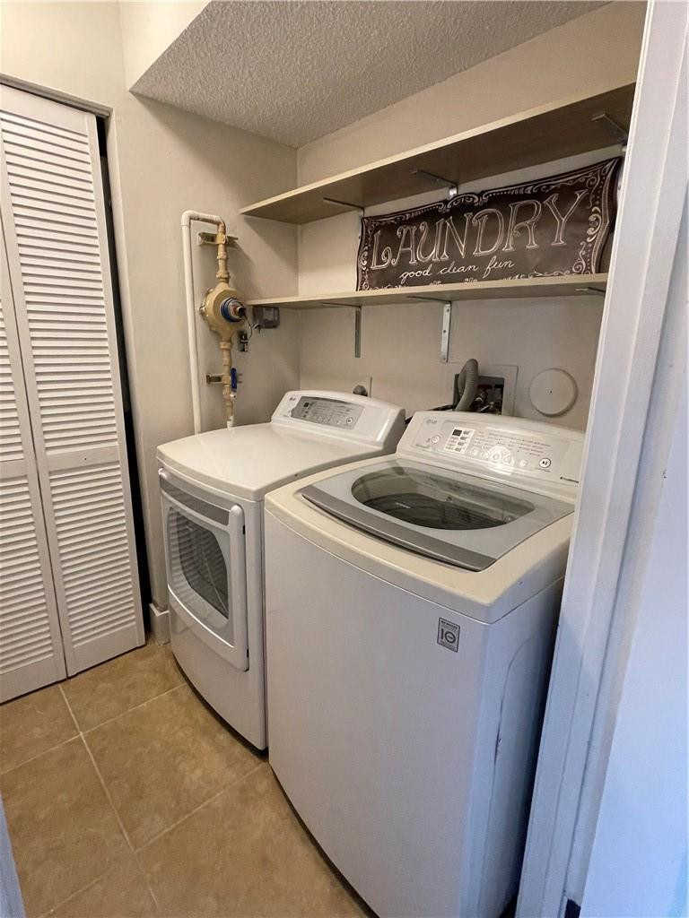 8801 Wiles Road, Unit 108 Coral Springs, FL 33067 - Photo 21 of 22 a utility room with dryer and washer