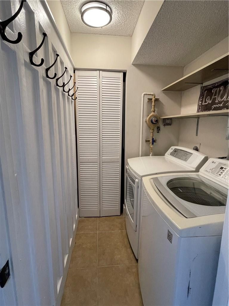 8801 Wiles Road, Unit 108 Coral Springs, FL 33067 - Photo 22 of 22 a utility room with dryer and washer