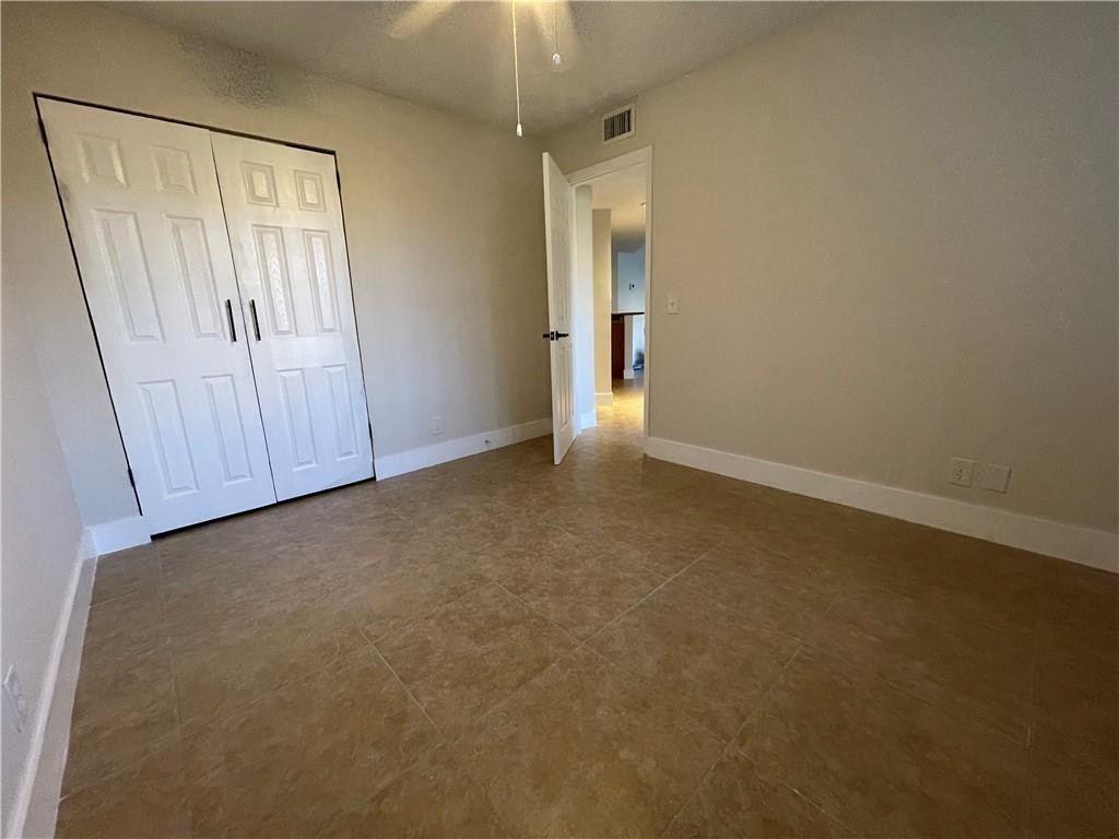 8801 Wiles Road, Unit 108 Coral Springs, FL 33067 - Photo 7 of 22 an empty room with closet and mirror