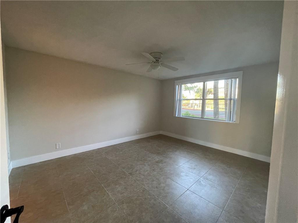 8801 Wiles Road, Unit 108 Coral Springs, FL 33067 - Photo 9 of 22 an empty room with a window