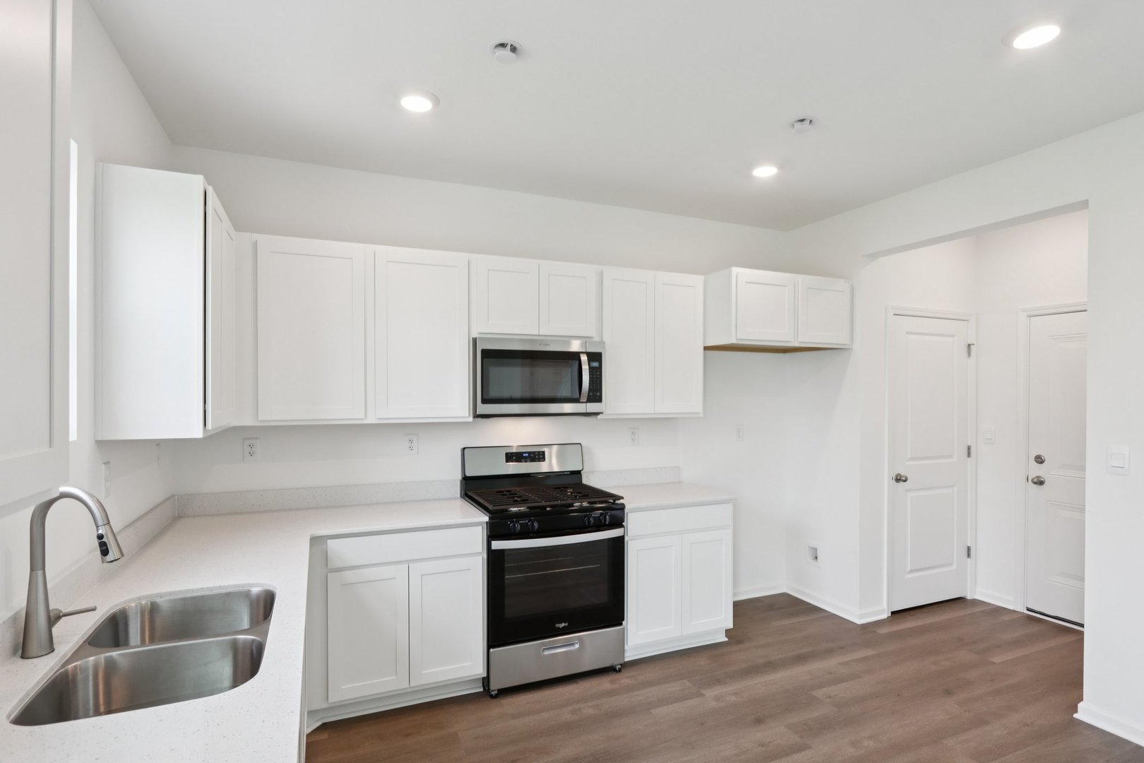 1812 Overland Drive Plainfield, IL 60586 - Photo 8 of 42 a kitchen with granite countertop white cabinets and black stainless steel appliances