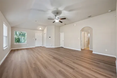 wooden floor in an empty room with a window