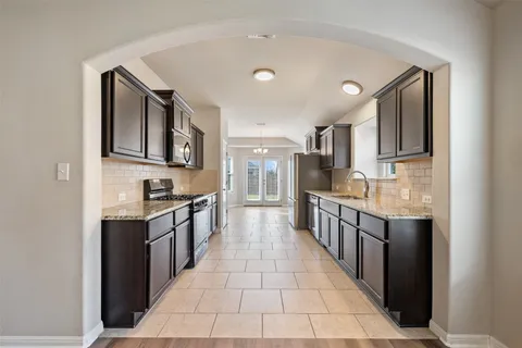 a large kitchen with stainless steel appliances lots of counter top space