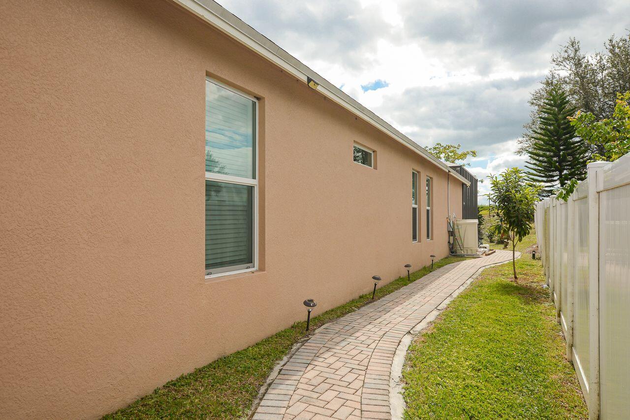 341 Southwest Kestor Drive, Unit 341 Port St. Lucie, FL 34953 - Photo 15 of 19 a house view with a backyard space