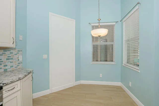a view of an empty room with window and cabinet