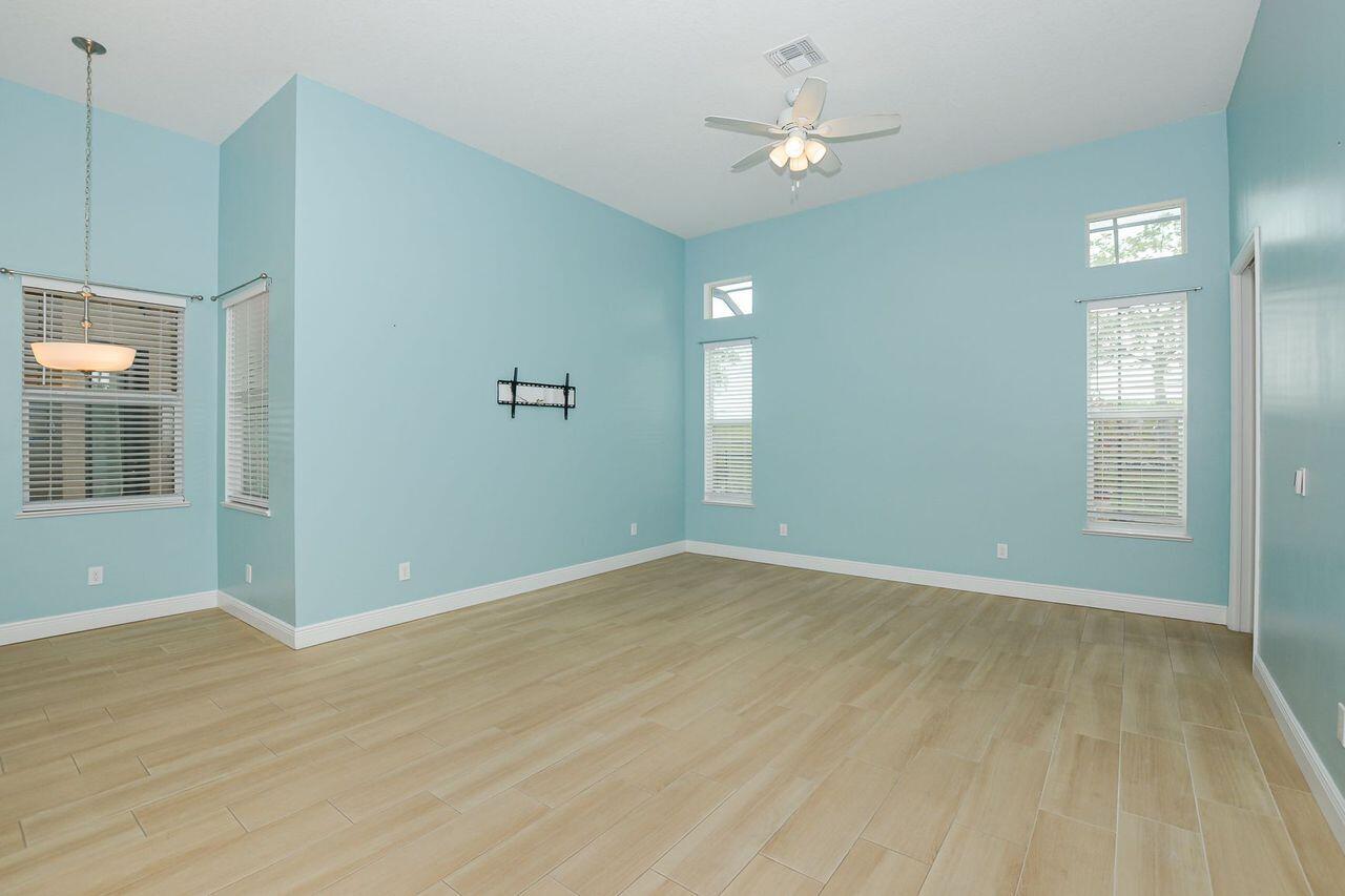 341 Southwest Kestor Drive, Unit 341 Port St. Lucie, FL 34953 - Photo 4 of 19 wooden floor in an empty room with a window