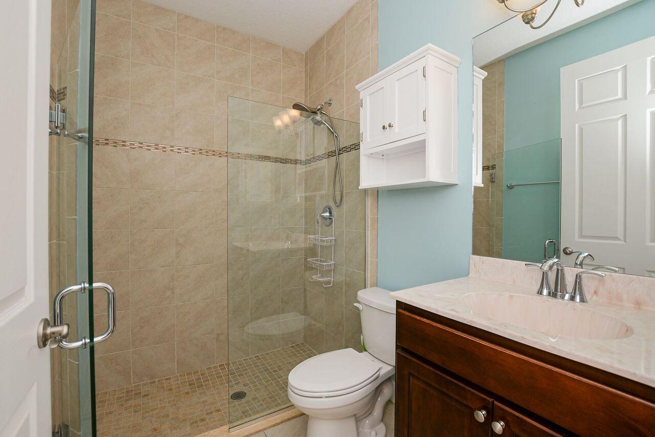 341 Southwest Kestor Drive, Unit 341 Port St. Lucie, FL 34953 - Photo 7 of 19 a bathroom with a sink a toilet and shower