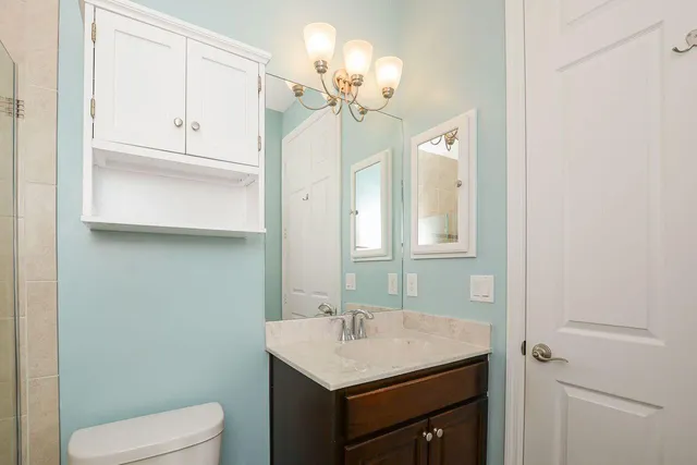 a bathroom with a sink vanity and toilet