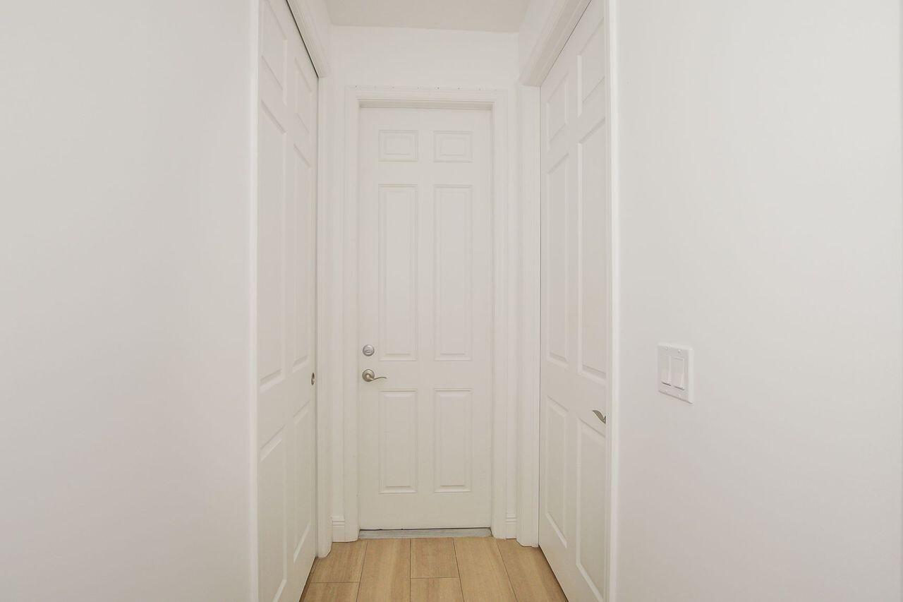 341 Southwest Kestor Drive, Unit 341 Port St. Lucie, FL 34953 - Photo 10 of 19 a view of a bedroom from the hallway