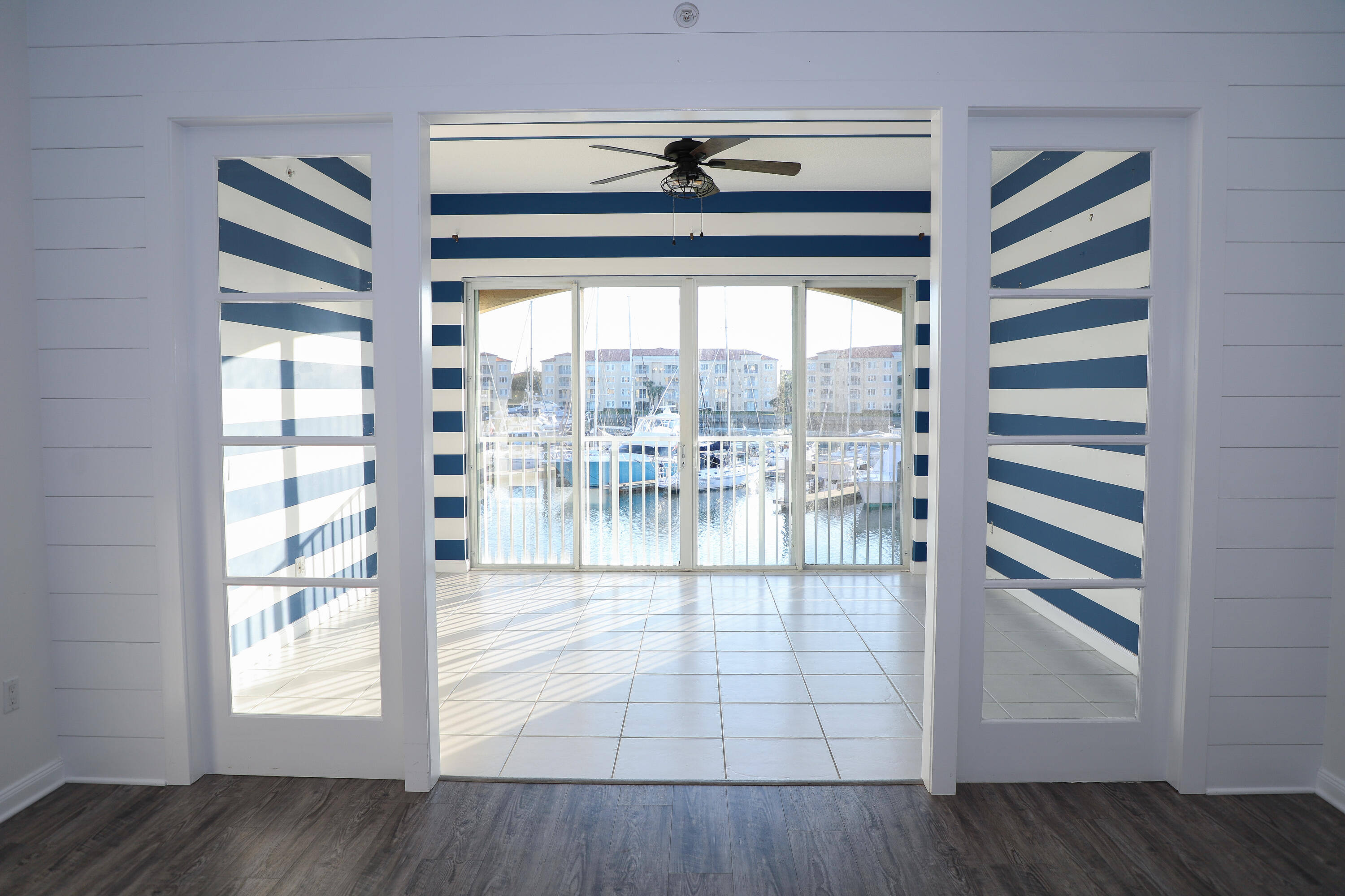 10 Harbour Isle Drive East, Unit 206 Fort Pierce, FL 34949 - Photo 2 of 12 a view of empty room with wooden floor and fan