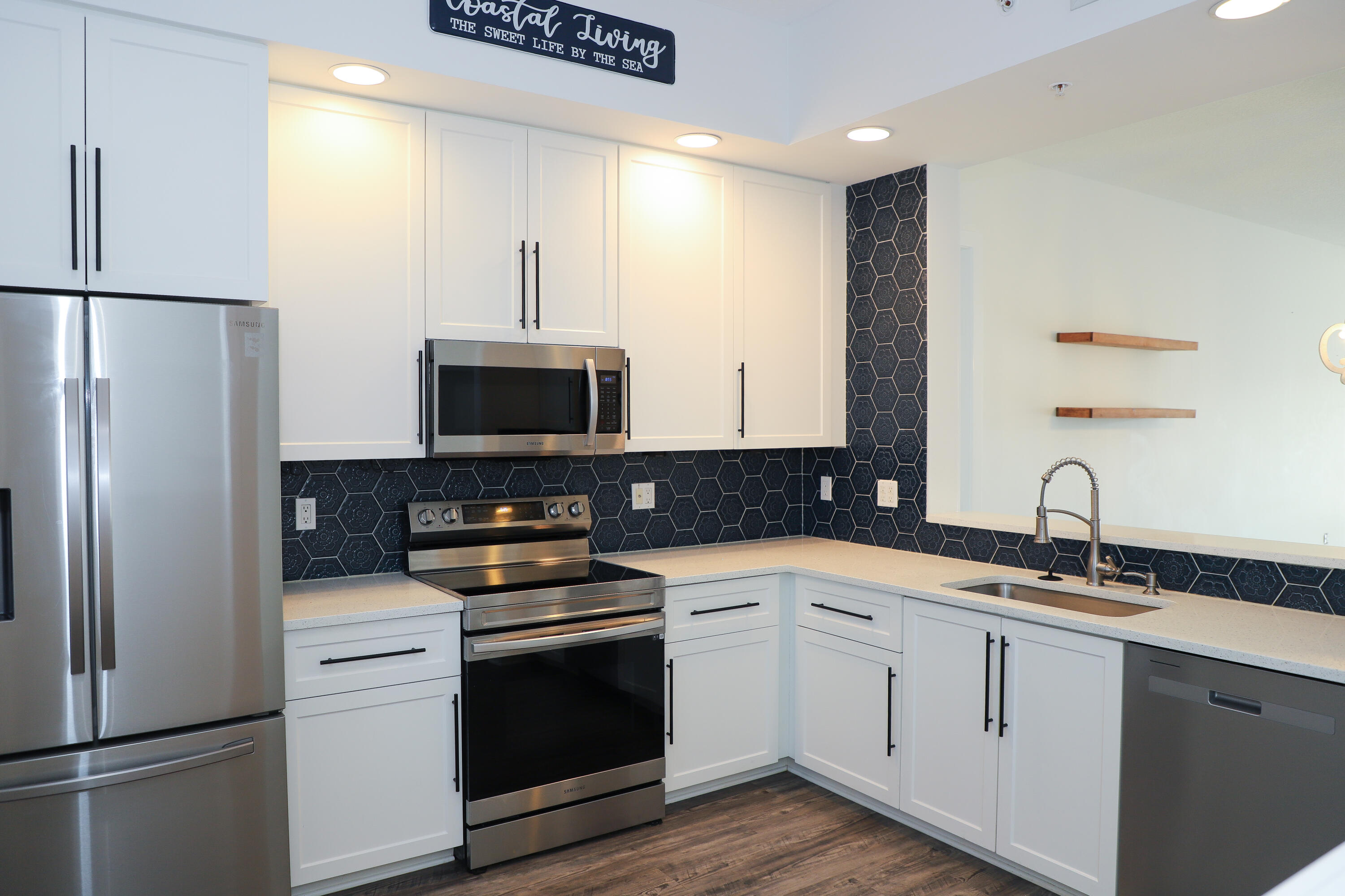 10 Harbour Isle Drive East, Unit 206 Fort Pierce, FL 34949 - Photo 5 of 12 a kitchen with a sink and a refrigerator