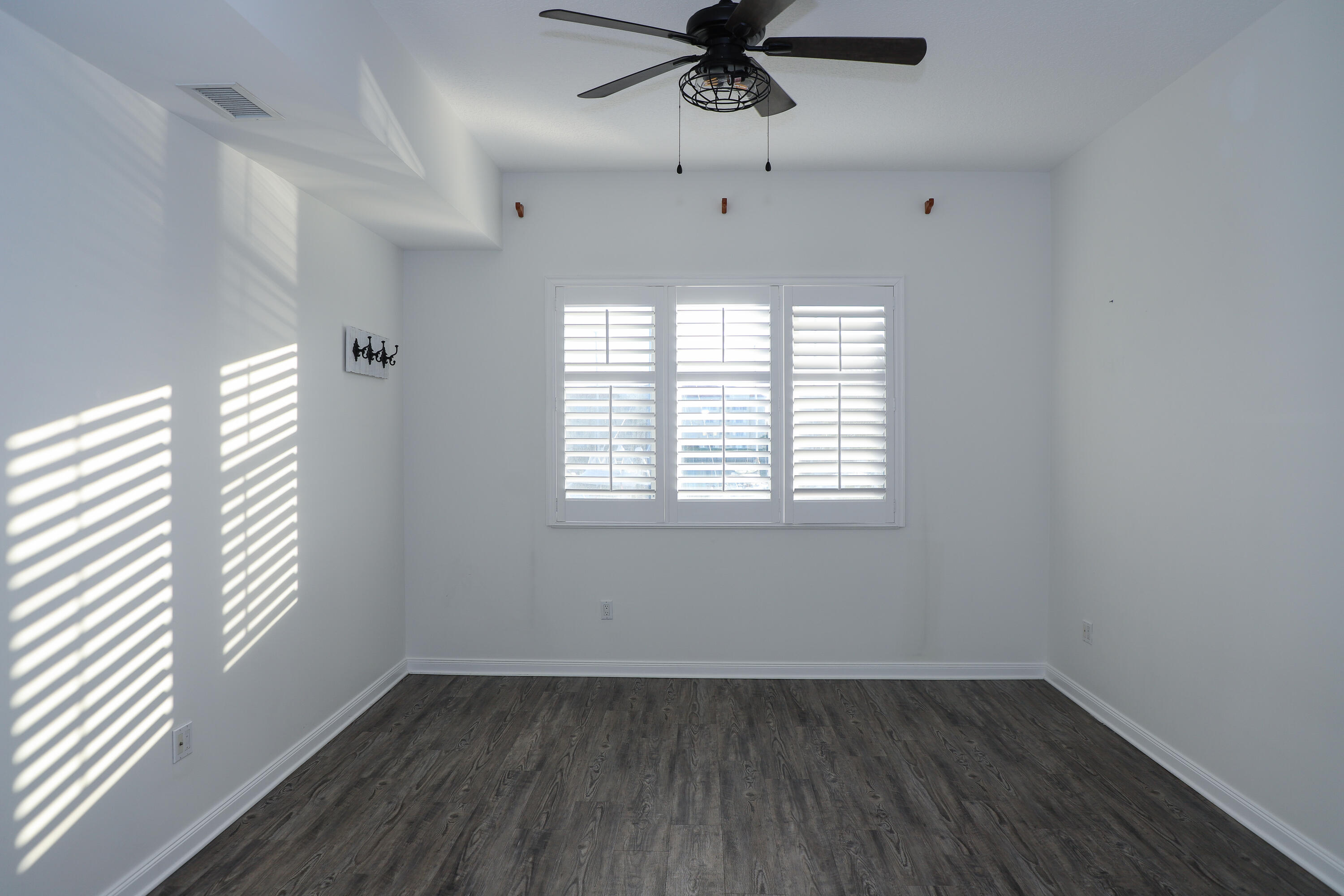 10 Harbour Isle Drive East, Unit 206 Fort Pierce, FL 34949 - Photo 7 of 12 wooden floor in an empty room with a window