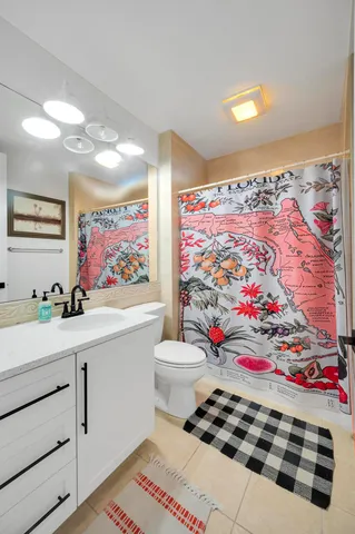 a room with painting on the wall and a rug