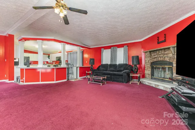 a living room with furniture a fireplace and flat screen tv