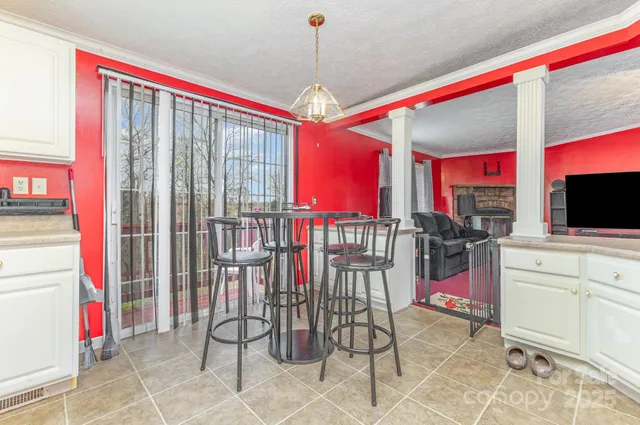a utility room with stainless steel appliances granite countertop a sink and cabinets