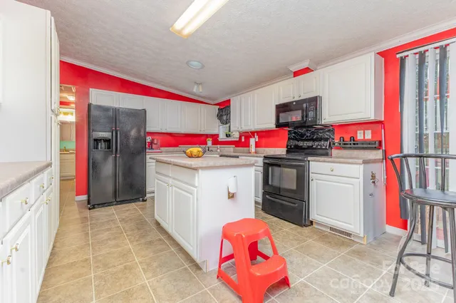 a bedroom with a bed and large window