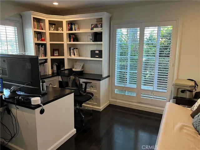 a work room with furniture and flat screen tv