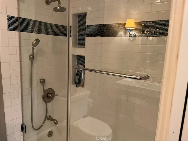 a bathroom with a sink mirror and toilet