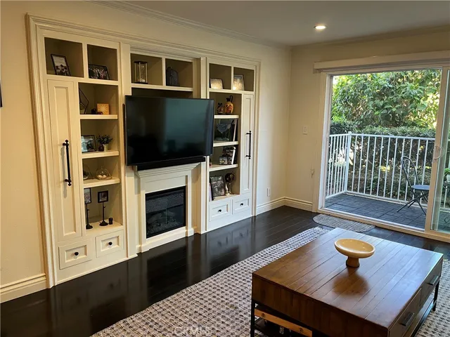 a living room with flat screen tv and a fireplace