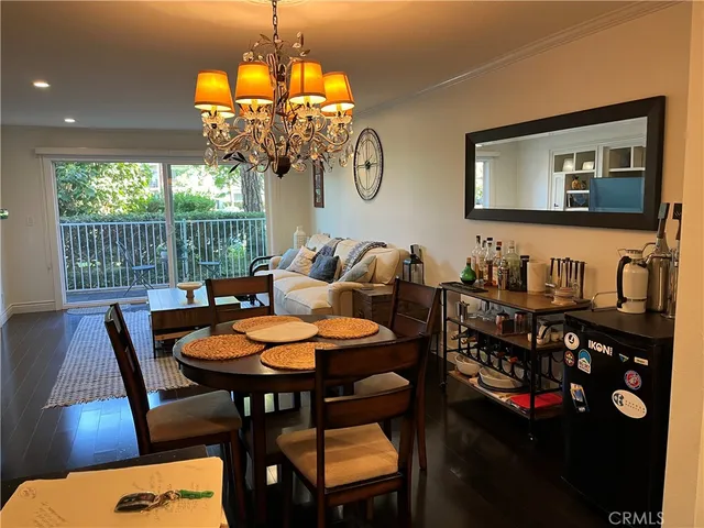 a view of a dining room with furniture wooden floor and chandelier