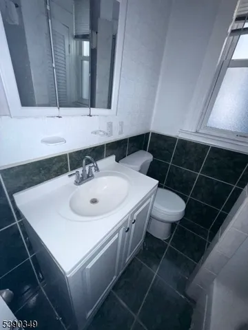 a bathroom with a sink toilet and a mirror