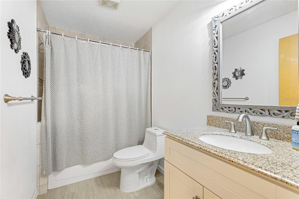4537 South Lockwood Ridge Road Sarasota, FL 34231 - Photo 17 of 22 a bathroom with a granite countertop sink toilet and shower