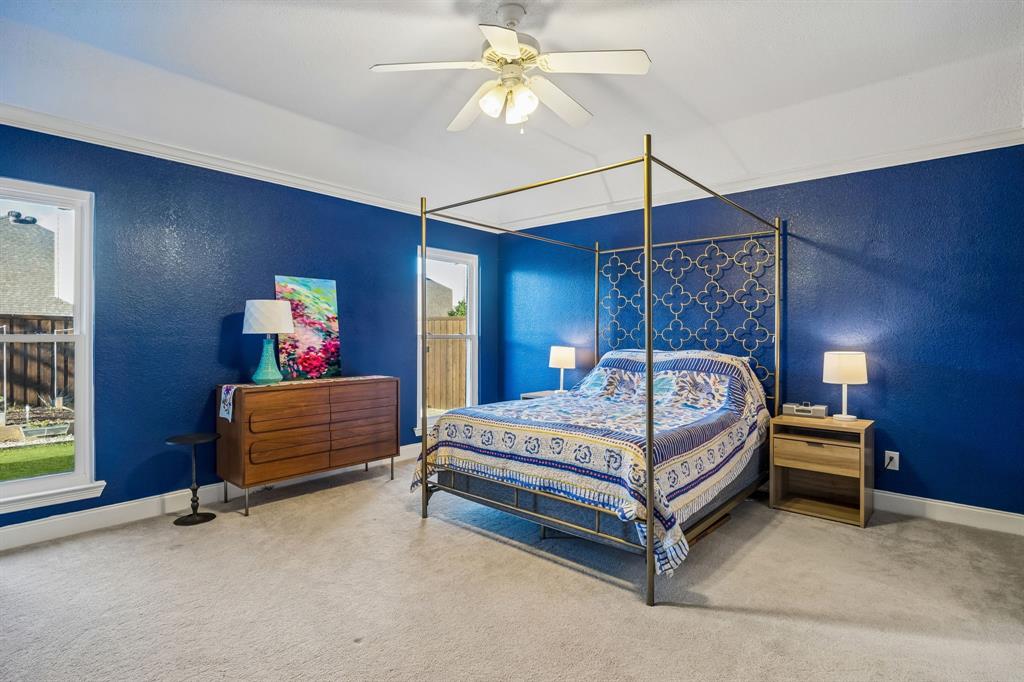12404 Ark Road Frisco, TX 75035 - Photo 14 of 28 a bedroom with a bed a chandelier and a chandelier