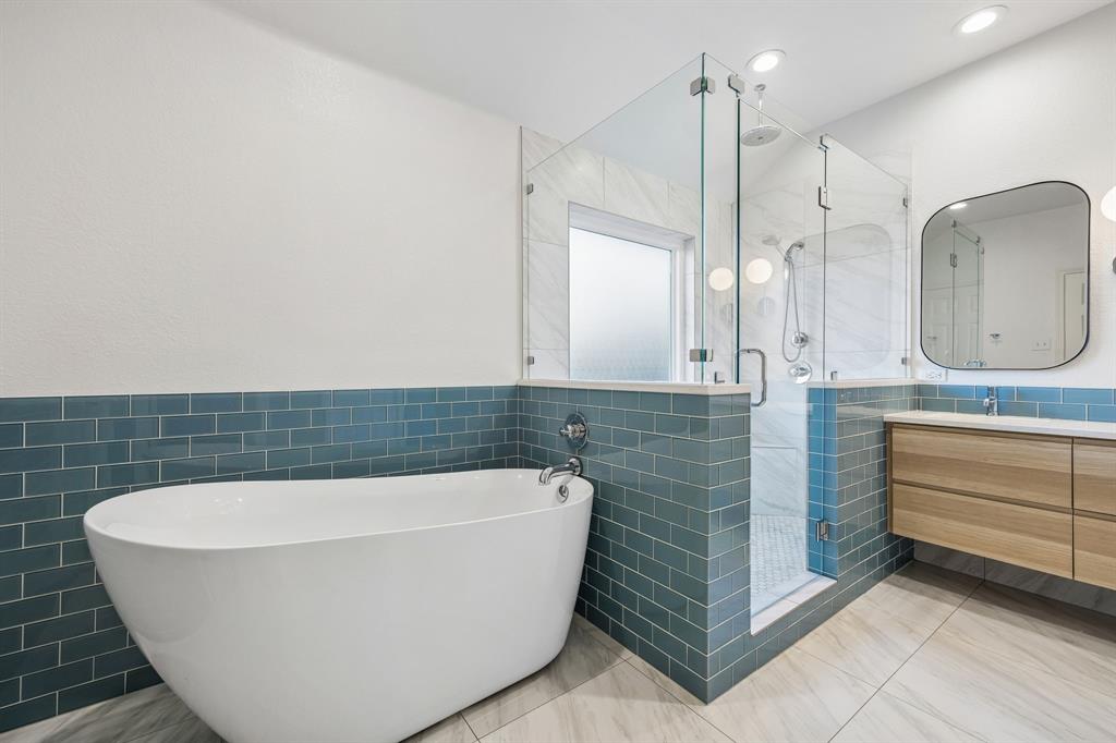 12404 Ark Road Frisco, TX 75035 - Photo 18 of 28 a bathroom with a bathtub and shower