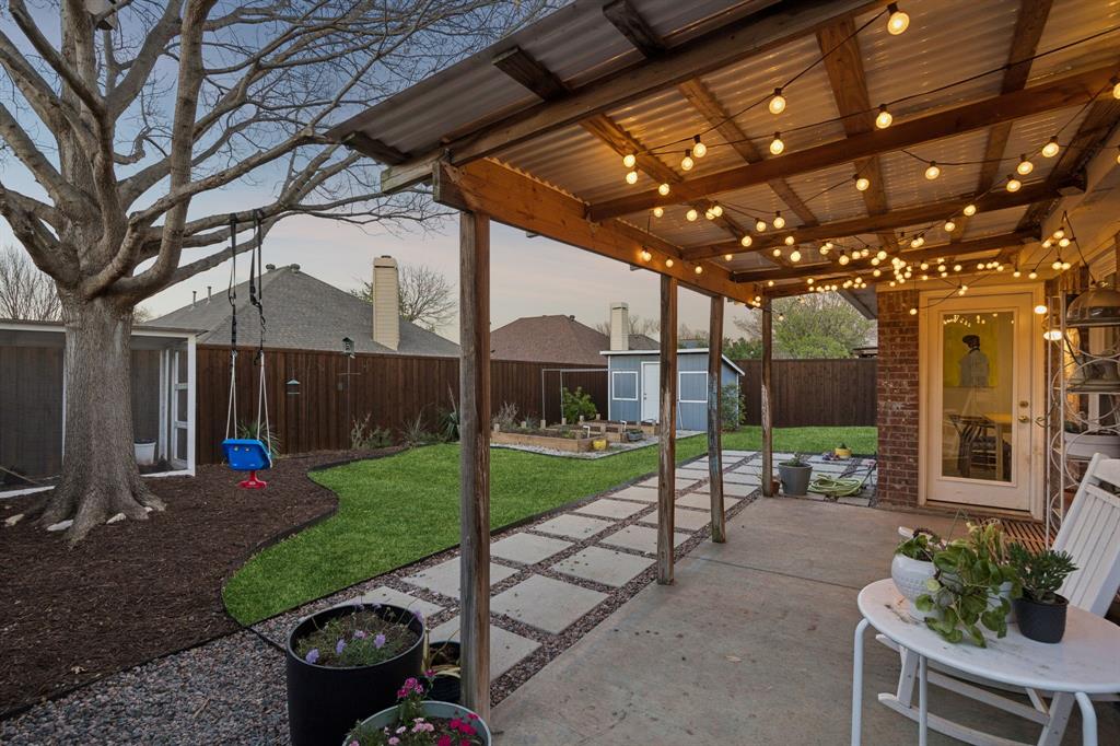 12404 Ark Road Frisco, TX 75035 - Photo 24 of 28 a view of a chair and tables under an umbrella in patio