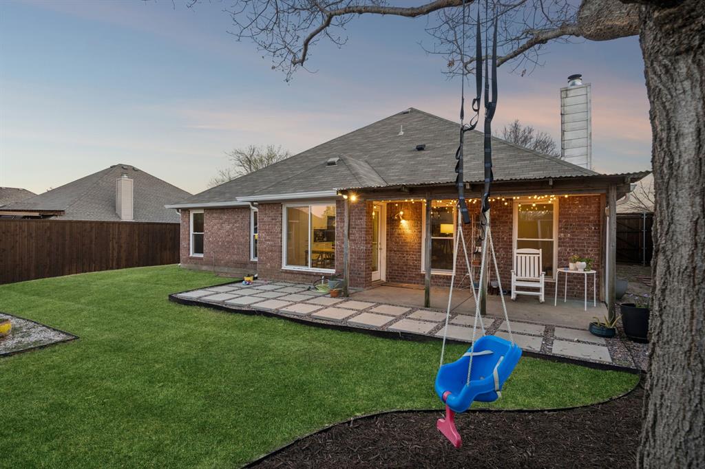 12404 Ark Road Frisco, TX 75035 - Photo 25 of 28 a front view of a house with a yard table and chairs