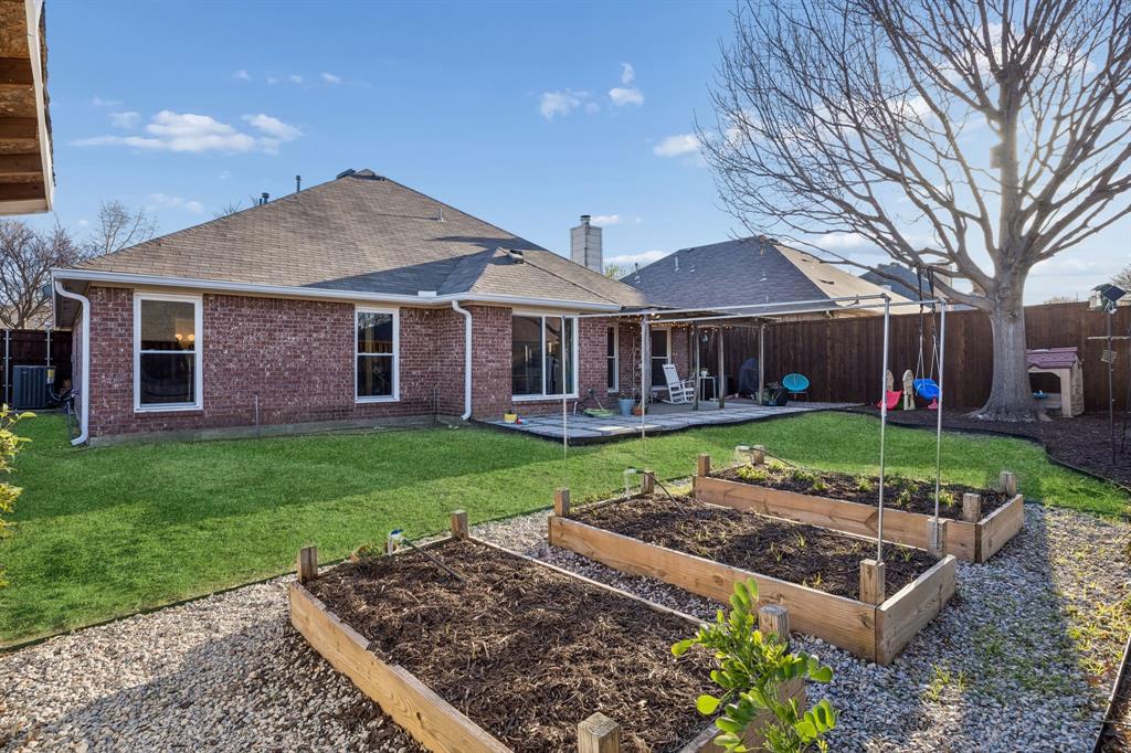 12404 Ark Road Frisco, TX 75035 - Photo 27 of 28 a front view of a house with a garden